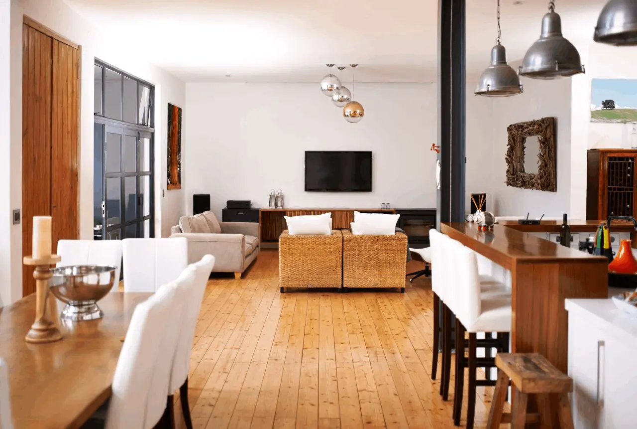 A living room with wooden floors and white walls.